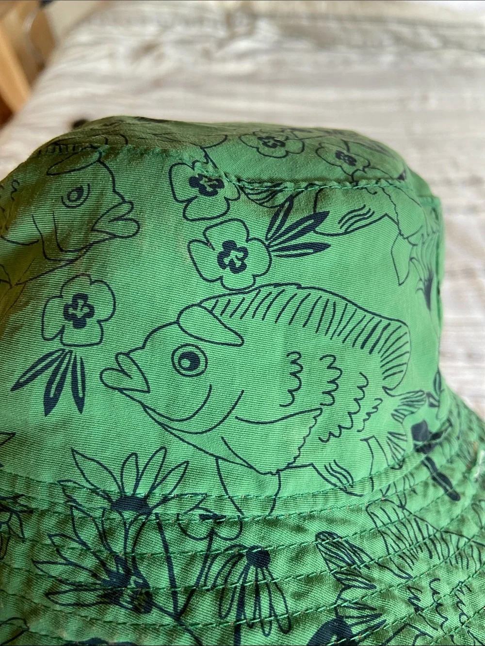 Patagonia Green Kids Sun Bucket Hat with Navy Fish and Floral Print.